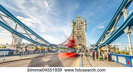 Stock Photo - Red double-decker bus on the Tower Bridge with passers-by, motion blur, Southwark, London, England, Great Britain. Fotosearch