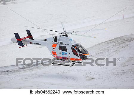 Stock Image - Rescue helicopter of the Austrian Red Cross in operation on the Dachstein glacier, mountain station on the Dachstein, Schladminger Tauern, Styria, Austria, Europe. Fotosearch