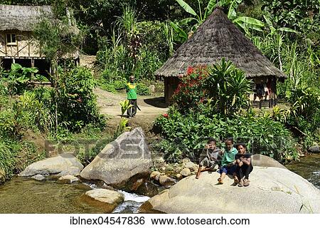 Stock Photograph - Residents in small village, highlands of Kaveve, Goroka, Papua New Guinea, Oceania. Fotosearch