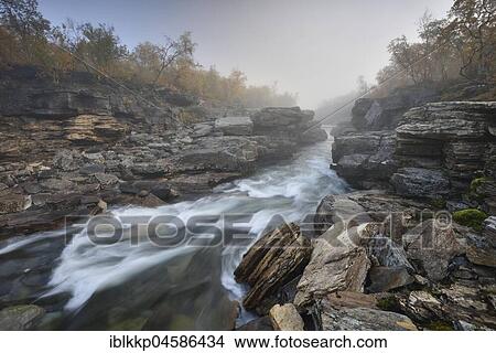 River Abiskojakka River flows through Abisko Canyon, river landscape in autumn at morning fog, Abisko National Park, Sweden, Europe View Large Photo Image Picture - River Abiskojakka River flows through Abisko Canyon, river landscape in autumn at morning fog, Abisko National Park, Sweden, Europe. Fotosearch