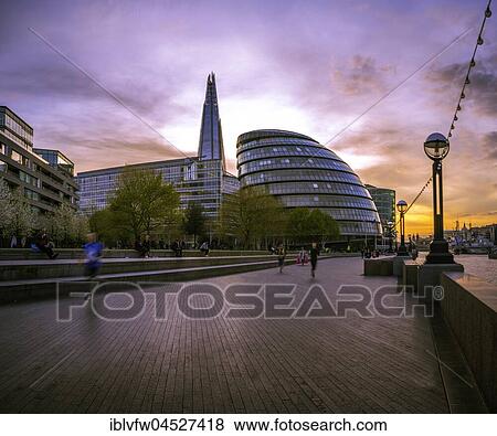 Stock Photo - Riverside promenade on the Thames, Potters Fields Park, Skyline, London City Hall, The Shard, at sunset, Southwark, London, England, United Kingdom, Europe. Fotosearch