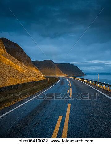 Road leading to rainbow with dramatic sky and sunset light, Sarnes, North Cape, Norway, Europe View Large Photo Image Stock Image - Road leading to rainbow with dramatic sky and sunset light, Sarnes, North Cape, Norway, Europe. Fotosearch