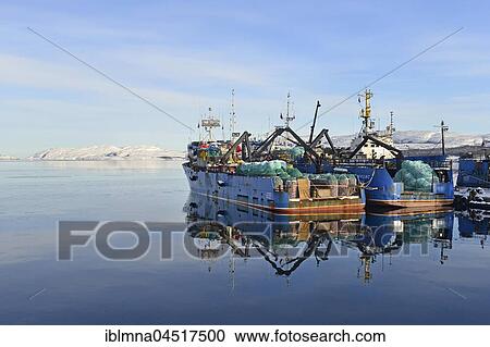 Stock Image - Rusty Russian fishing boats in harbor, Kirkenes, Finnmark County, Norway, Europe. Fotosearch
