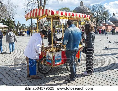 Stock Photography - Salesman at his Sweet chestnut stall in Sultan Ahmed Park, Sultanahmet, European part, Istanbul, Turkey, Asia. Fotosearch
