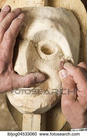 Stock Image - Sanding the face of a wooden mask, wooden mask carver, Bad Aussee, Styria, Austria, Europe. Fotosearch