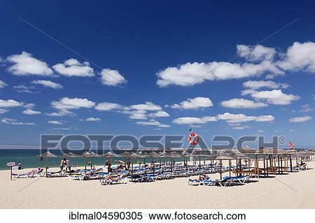 Sandy beach beach with umbrellas and sunbeds, Praia de tres Irmaos, Alvor, Algarve, Portugal, Europe View Large Photo Image Stock Photography - Sandy beach beach with umbrellas and sunbeds, Praia de tres Irmaos, Alvor, Algarve, Portugal, Europe. Fotosearch