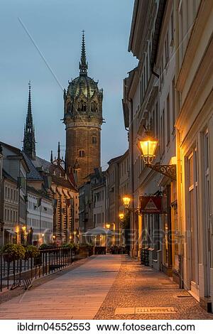 Schlossstraße with tower of the castle church, evening atmosphere, Luther city Wittenberg, Saxony-Anhalt, Germany, Europe View Large Photo Image Stock Image - Schlossstraße with tower of the castle church, evening atmosphere, Luther city Wittenberg, Saxony-Anhalt, Germany, Europe. Fotosearch