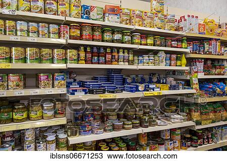 Stock Image - Shelf with food, canned food and jars, Germany, Europe. Fotosearch