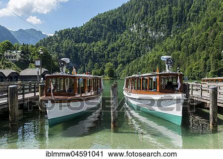 Stock Image - Ships at Königssee, National Park Berchtesgaden, Berchtesgaden area, Upper Bavaria, Bavaria, Germany, Europe. Fotosearch