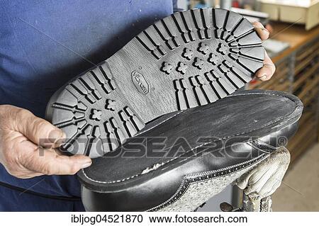 Shoemaker, hands holding outsole, underneath half-finished shoe with sewn-on soles on work stand, Kainisch, Styria, Austria, Europe View Large Photo Image Stock Image - Shoemaker, hands holding outsole, underneath half-finished shoe with sewn-on soles on work stand, Kainisch, Styria, Austria, Europe. Fotosearch