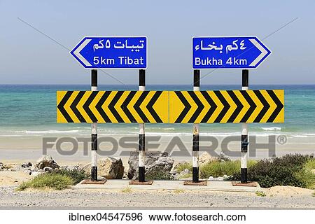Stock Photograph - Sign posts on the road, different directions, peninsula Musandam, Oman, Asia. Fotosearch