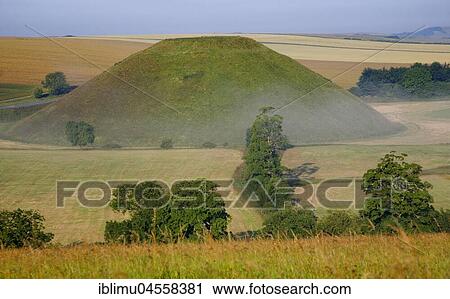 Stock Image - Silbury Hill, prehistoric artificial chalk, near Avebury, Wiltshire, England, Great Britain. Fotosearch