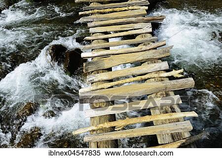 Stock Photography - Simple wooden bridge over river, highlands of Kaveve, Goroka, Papua New Guinea, Oceania. Fotosearch