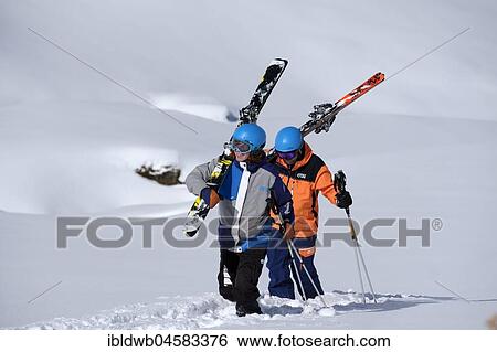 Stock Photograph - Skiers walking with shoulderd skis in the snow, Freerider, Hochfügen, Zillertal, Tyrol, Austria, Europe. Fotosearch