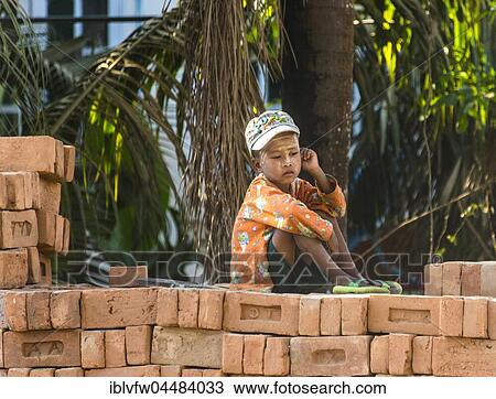 Small indigenous boy sitting on brick wall, street scene, Chaung Tha Beach, Myanmar, Asia View Large Photo Image Stock Image - Small indigenous boy sitting on brick wall, street scene, Chaung Tha Beach, Myanmar, Asia. Fotosearch