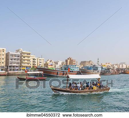 Stock Image - Small traditional ships and old dhow on the creek, Old Dubai, United Arab Emirates, Asia. Fotosearch