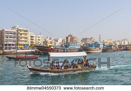 Stock Image - Small traditional ships and old dhow on the creek, Old Dubai, United Arab Emirates, Asia. Fotosearch