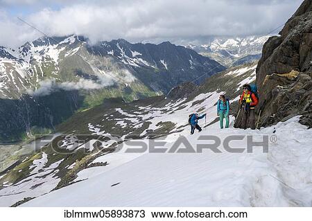 Stock Image - Snow field, Hiker on the way to the Schönblichler Horn, Path from Furtschaglhaus to the Berliner Hütte, High alpine landscape, Berlin Höhenweg, Zillertal Alps, Zillertal, Tyrol, Austria, Europe. Fotosearch