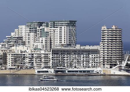 Stock Photo - Spit of land with office and apartment buildings, hotel tower Fortina Spa Resort, Sliema, Malta, Europe. Fotosearch