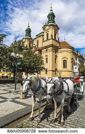Stock Photo - St. Nicholas Church, in front of it a horse-drawn carriage, Old Town Square, Eastern Old Town, Prague, Czech Republic, Europe. Fotosearch