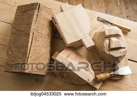 Stock Photography - Steps from wooden block to wooden mask, wooden block and unfinished masks on workbench with wood carving tools, wooden mask carver, Bad Aussee, Styria, Austria, Europe. Fotosearch