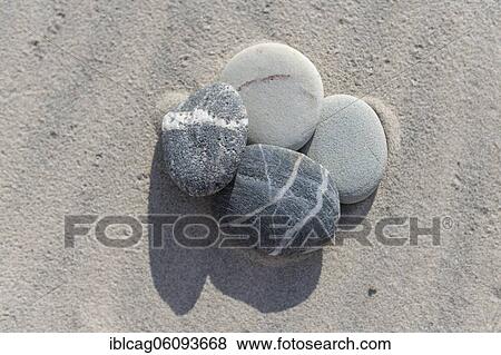 Stock Photo - Stones in the sand, Hen beach, Jutland, Denmark, Europe. Fotosearch
