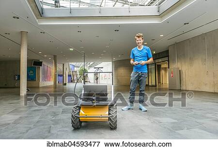 Student with robot Auto Husky of the company Clearpath, autonomic driving, University of Applied Sciences Munich, Bavaria, Germany, Europe View Large Photo Image Stock Photo - Student with robot Auto Husky of the company Clearpath, autonomic driving, University of Applied Sciences Munich, Bavaria, Germany, Europe. Fotosearch