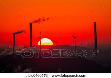 Sunset in front of Scholven power plant, Uniper power plants, red sky, chimneys, wind power plants, Halde Oberscholven wind farm, Gelsenkirchen, Ruhr Area, North Rhine-Westphalia, Germany, Europe View Large Photo Image Picture - Sunset in front of Scholven power plant, Uniper power plants, red sky, chimneys, wind power plants, Halde Oberscholven wind farm, Gelsenkirchen, Ruhr Area, North Rhine-Westphalia, Germany, Europe. Fotosearch