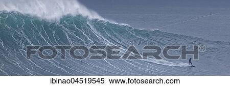 Stock Photography - Surfers in a wave, Nazare, Portugal, Europe. Fotosearch