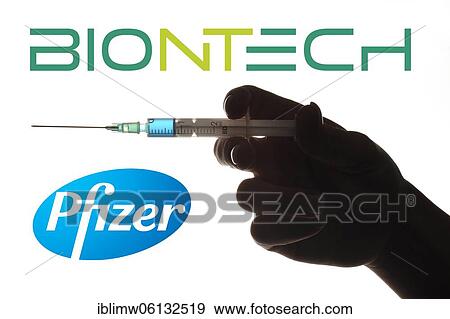 Stock Photo - Symbol image Corona vaccine from BIONTECH, PFIZER, hand with syringe, corona crisis, Baden-Württemberg, Germany, Europe. Fotosearch