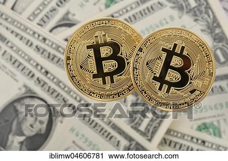 Stock Image - Symbol image cryptocurrency, digital currency, golden physical coin Bitcoin on US dollar banknotes. Fotosearch
