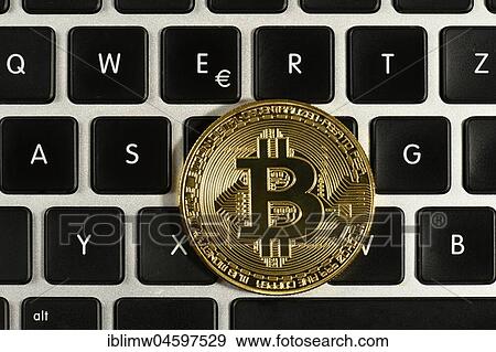 Symbol image digital currency, gold physical coin bitcoin on keyboard View Large Photo Image Stock Photo - Symbol image digital currency, gold physical coin bitcoin on keyboard. Fotosearch