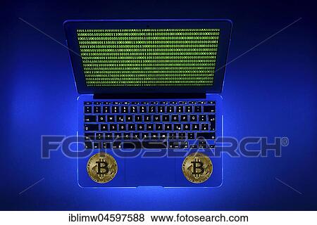 Stock Photo - Symbol image digital currency, gold physical coin bitcoin laptop with digital binary code. Fotosearch