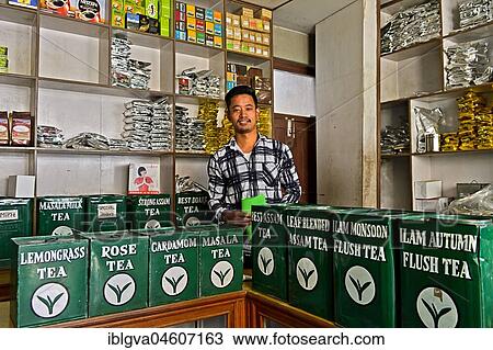 Stock Image - Tea merchant behind large tins with tea in his shop, Kathmandu, Nepal, Asia. Fotosearch