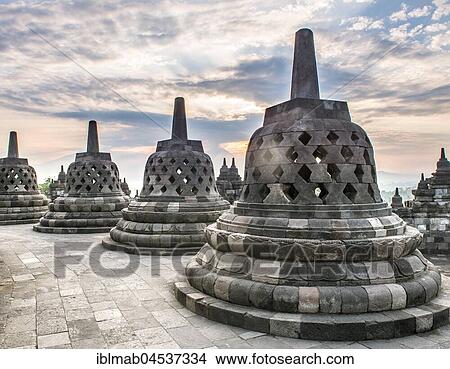 Temple complex Borobudur at sunrise, Stupas, cloudy sky, Borobudur, Yogyakarta, Java, Indonesia, Asia View Large Photo Image Picture - Temple complex Borobudur at sunrise, Stupas, cloudy sky, Borobudur, Yogyakarta, Java, Indonesia, Asia. Fotosearch