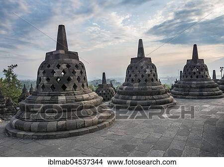 Temple complex Borobudur at sunrise, Stupas, cloudy sky, Borobudur, Yogyakarta, Java, Indonesia, Asia View Large Photo Image Picture - Temple complex Borobudur at sunrise, Stupas, cloudy sky, Borobudur, Yogyakarta, Java, Indonesia, Asia. Fotosearch