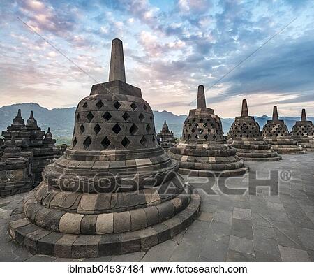 Picture - Temple complex Borobudur at sunrise, Stupas, cloudy sky, Borobudur, Yogyakarta, Java, Indonesia, Asia. Fotosearch