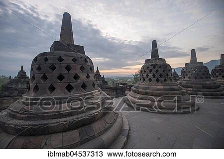 Temple complex Borobudur at sunrise, Stupas, cloudy sky, Borobudur, Yogyakarta, Java, Indonesia, Asia View Large Photo Image Stock Image - Temple complex Borobudur at sunrise, Stupas, cloudy sky, Borobudur, Yogyakarta, Java, Indonesia, Asia. Fotosearch