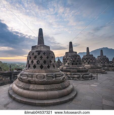 Stock Image - Temple complex Borobudur at sunrise, Stupas, cloud sky, Borobudur, Yogyakarta, Java, Indonesia, Asia. Fotosearch