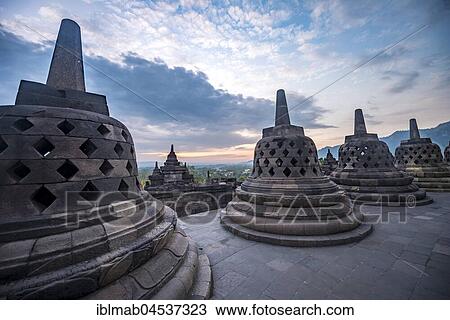 Temple complex Borobudur at sunrise, Stupas, cloudy sky, Borobudur, Yogyakarta, Java, Indonesia, Asia View Large Photo Image Stock Image - Temple complex Borobudur at sunrise, Stupas, cloudy sky, Borobudur, Yogyakarta, Java, Indonesia, Asia. Fotosearch