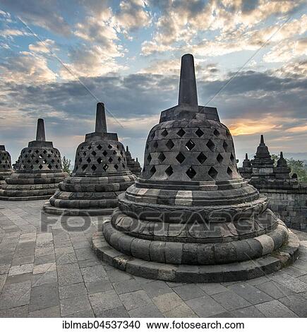 Temple complex Borobudur at sunrise, Stupas, cloudy sky, Borobudur, Yogyakarta, Java, Indonesia, Asia View Large Photo Image Stock Image - Temple complex Borobudur at sunrise, Stupas, cloudy sky, Borobudur, Yogyakarta, Java, Indonesia, Asia. Fotosearch