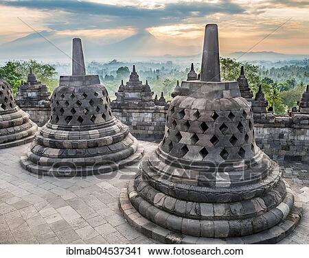 Temple complex Borobudur at sunrise, Stupas, cloudy sky, Borobudur, Yogyakarta, Java, Indonesia, Asia View Large Photo Image Stock Image - Temple complex Borobudur at sunrise, Stupas, cloudy sky, Borobudur, Yogyakarta, Java, Indonesia, Asia. Fotosearch