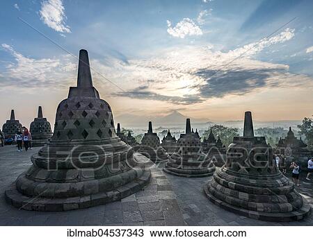 Temple complex Borobudur at sunrise, Stupas, cloudy sky, Borobudur, Yogyakarta, Java, Indonesia, Asia View Large Photo Image Stock Image - Temple complex Borobudur at sunrise, Stupas, cloudy sky, Borobudur, Yogyakarta, Java, Indonesia, Asia. Fotosearch