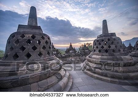 Stock Photo - Temple complex Borobudur at sunrise, Stupas, cloudy sky, Borobudur, Yogyakarta, Java, Indonesia, Asia. Fotosearch