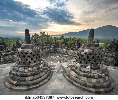 Temple complex Borobudur at sunrise, Stupas, cloudy sky, Borobudur, Yogyakarta, Java, Indonesia, Asia View Large Photo Image Stock Photo - Temple complex Borobudur at sunrise, Stupas, cloudy sky, Borobudur, Yogyakarta, Java, Indonesia, Asia. Fotosearch