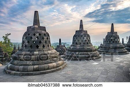 Temple complex Borobudur at sunrise, Stupas, cloudy sky, Borobudur, Yogyakarta, Java, Indonesia, Asia View Large Photo Image Stock Photo - Temple complex Borobudur at sunrise, Stupas, cloudy sky, Borobudur, Yogyakarta, Java, Indonesia, Asia. Fotosearch