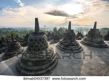 Temple complex Borobudur at sunrise, Stupas, cloudy sky, Borobudur, Yogyakarta, Java, Indonesia, Asia View Large Photo Image Stock Photo - Temple complex Borobudur at sunrise, Stupas, cloudy sky, Borobudur, Yogyakarta, Java, Indonesia, Asia. Fotosearch