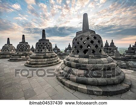 Temple complex Borobudur at sunrise, Stupas, cloudy sky, Borobudur, Yogyakarta, Java, Indonesia, Asia View Large Photo Image Stock Photo - Temple complex Borobudur at sunrise, Stupas, cloudy sky, Borobudur, Yogyakarta, Java, Indonesia, Asia. Fotosearch