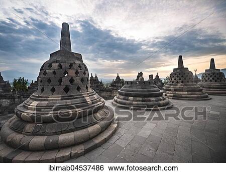 Temple complex Borobudur at sunrise, Stupas, cloudy sky, Borobudur, Yogyakarta, Java, Indonesia, Asia View Large Photo Image Stock Photograph - Temple complex Borobudur at sunrise, Stupas, cloudy sky, Borobudur, Yogyakarta, Java, Indonesia, Asia. Fotosearch