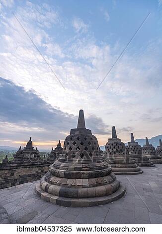 Temple complex Borobudur at sunrise, Stupas, cloudy sky, Borobudur, Yogyakarta, Java, Indonesia, Asia View Large Photo Image Stock Photography - Temple complex Borobudur at sunrise, Stupas, cloudy sky, Borobudur, Yogyakarta, Java, Indonesia, Asia. Fotosearch